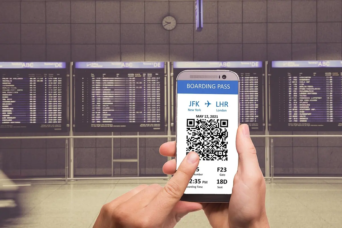 A phone showing a boarding pass at an airport