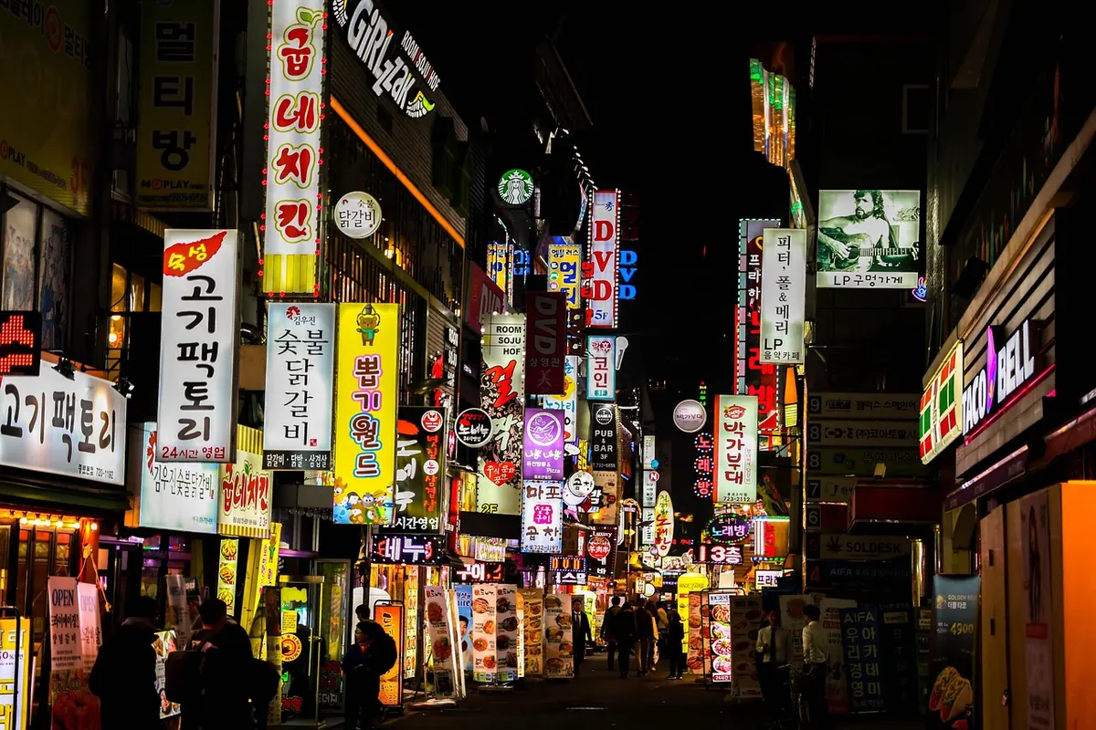 A Seoul street lined with Korean signs at night